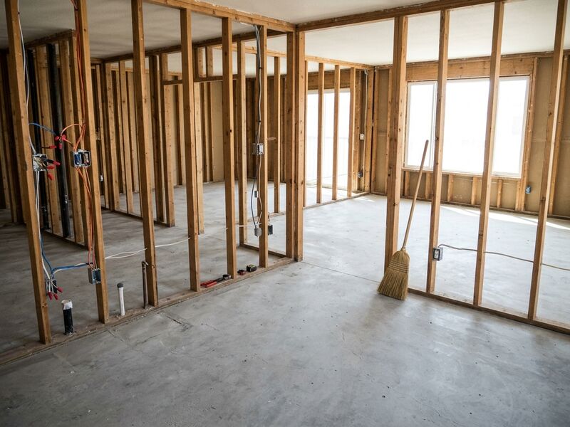 Empty apartment stripped to the studs and swept clean for the next trade